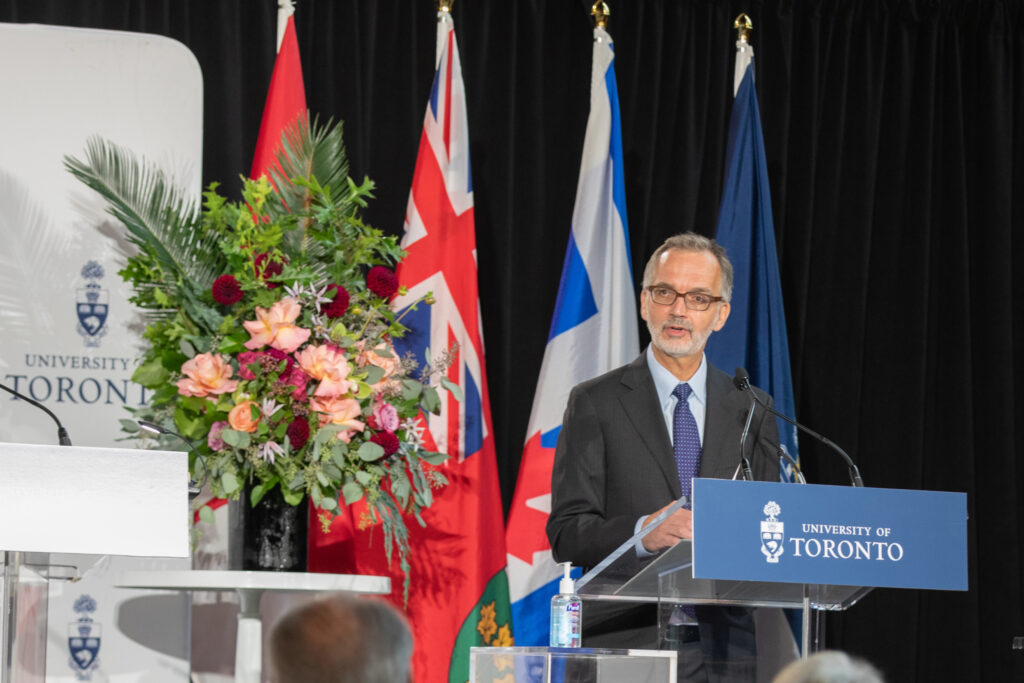 Dean of the Temerty Faculty of Medicine, Trevor Young, standing and speaking at the podium during the Temerty gift announcement event.