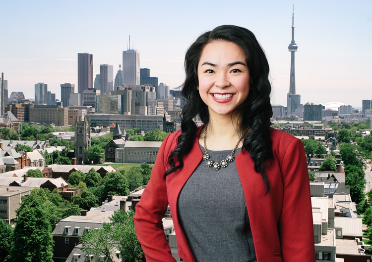 Photo of Anna Amy Ho smiling in front of the downtown Toronto skyline.