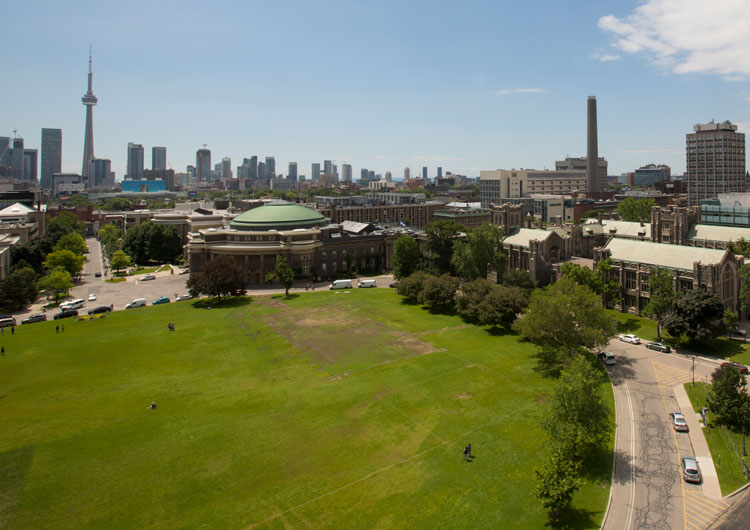 From the roof of University College, Front Campus looks lush, and is surrounded by U of T buildings and the Toronto skyline.