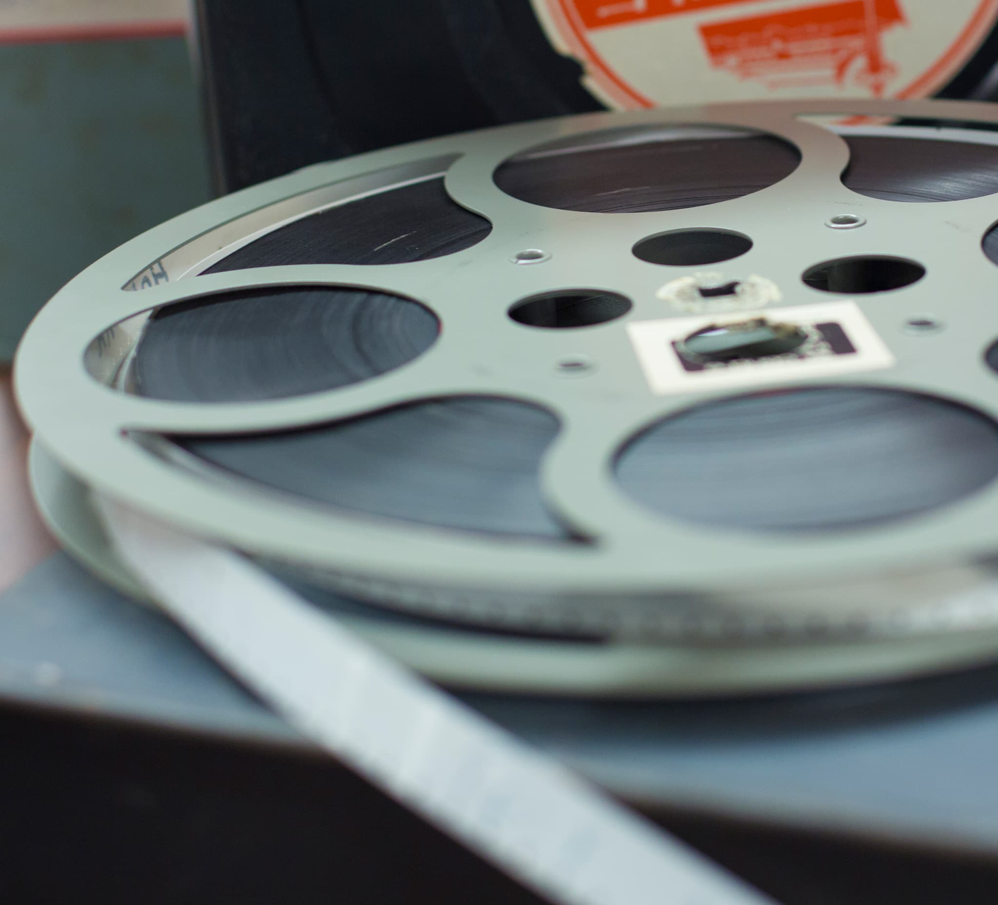 A close-up of an old-fashioned metal film reel.