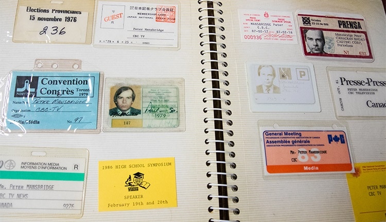 Peter Mansbridge collected his press passes from various events and speaking engagements, all neatly organized in an album.