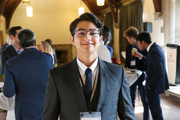 Vidur Narayan Channa smiles while taking part in a social reception in a large hall.