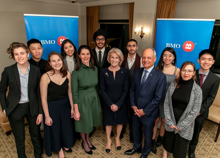 Some of the 2020 BMO Scholars gather with U of T leaders in front of banners bearing the BMO logo.