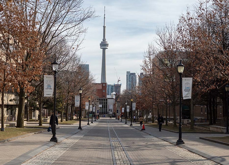 The CN Tower rises in the distance behind a nearly empty King's College Road