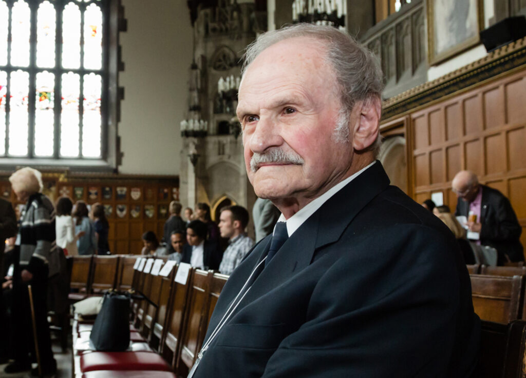 James Hosinec looks thoughtful as he sits on a bench in a wood-panelled room at Hart House.