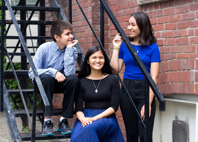 Katrina Florendo (centre) smiles with her son Jeremy (left) and daughter Auguste. Photo by Jackie Shapiro