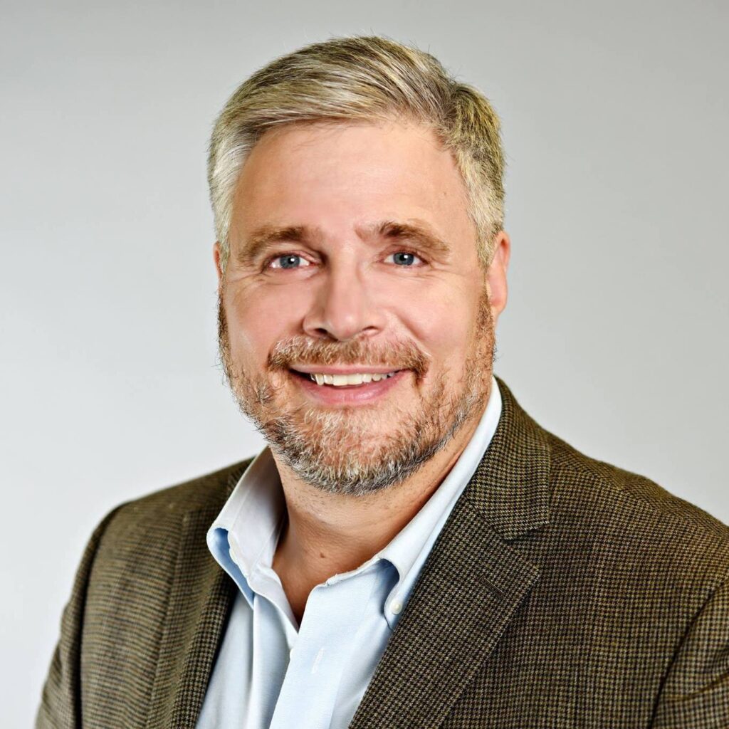 Portrait of Stephen Scharper smiling.