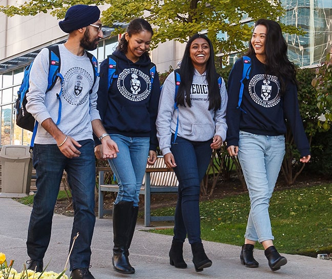 4 students wearing U of T sweatshirts laugh together: the image is next to the link to support your college or faculty.