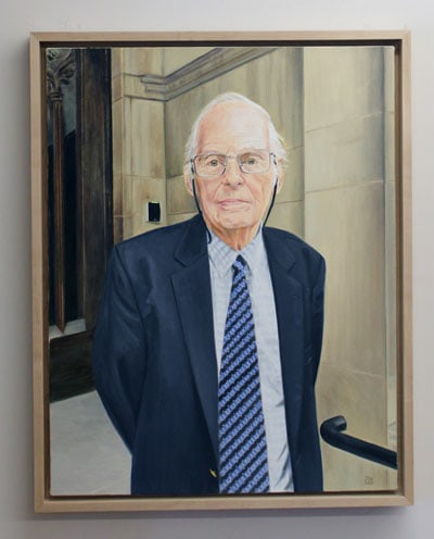 A framed painting depicts Michael. J. Trebilcock standing in a stone entranceway.