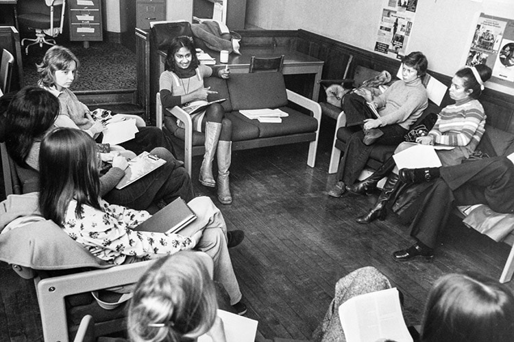 In a photo from 1975, Ceta Ramkhalawansingh chats with a class of women, sitting on comfy chairs in a circle.