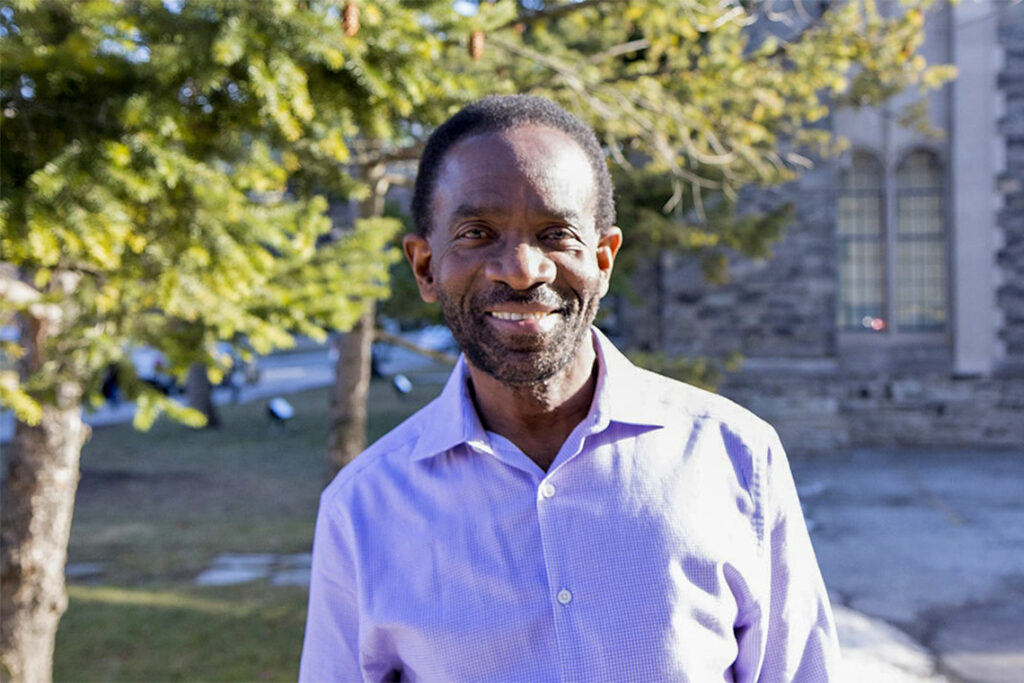 Glen Boothe smiles as he stands outdoors in the sunshine.