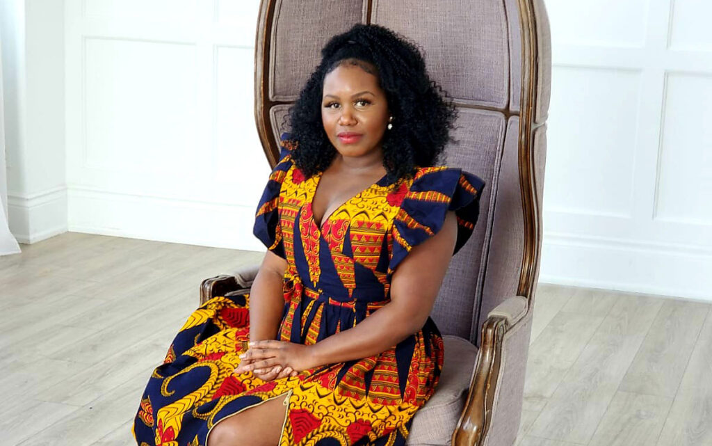 Melisa Ellis, founder of Nobellum, smiles as she sits in an oversized, throne-like chair.