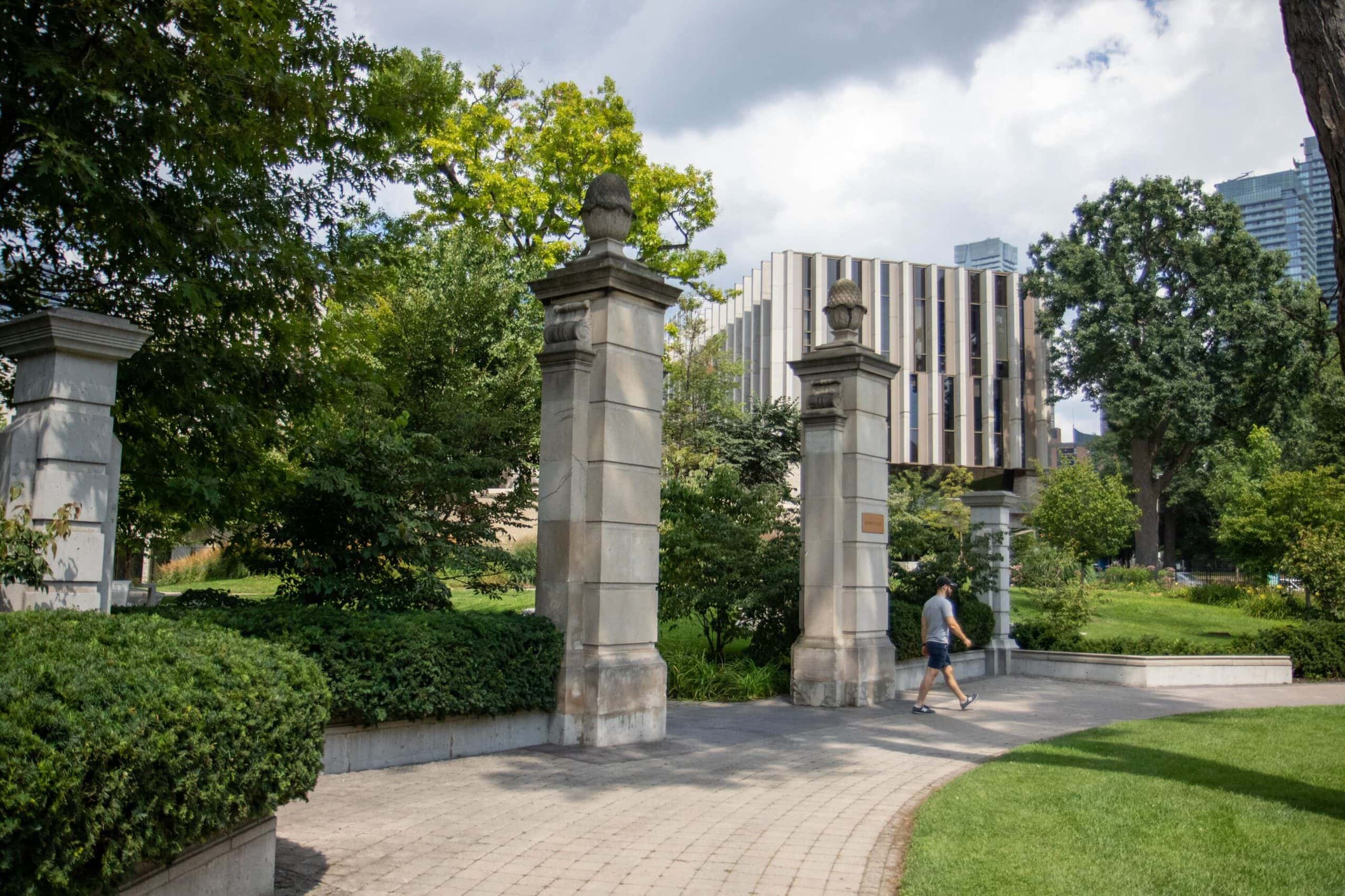 Stone pillars and bushes mark the entrance to the Philosopher's Walk pathway.