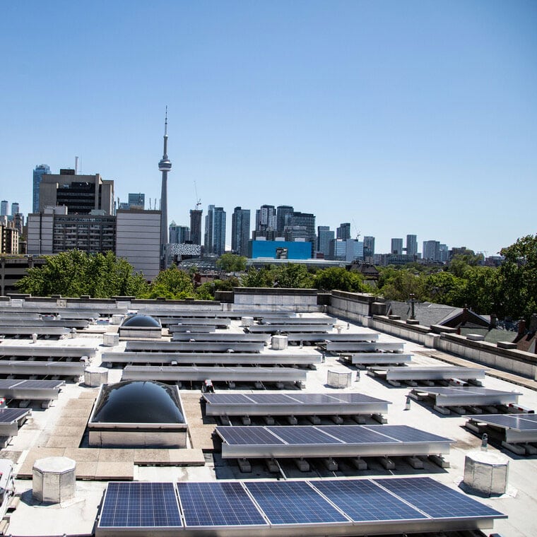 Solar panels cover the roof of 255 McCaul Street, looking over downtown Toronto and the CN Tower.