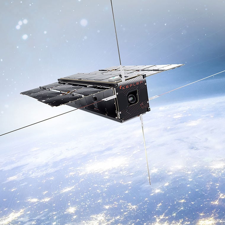 A box-shaped satellite, with solar panels spread out like wings, floats high above the Earth. A logo on its side says Kepler.