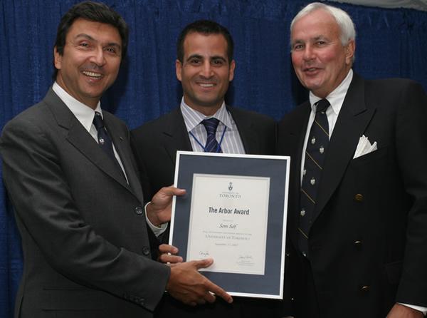 Som Seif holds a framed Arbor Award and poses with David Naylor and David Peterson.