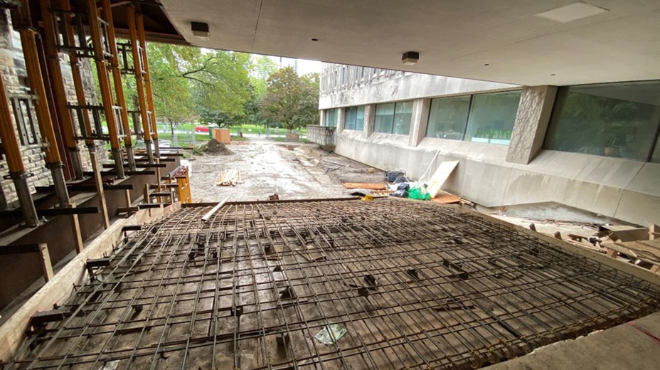 Looking out at Queen's Park, the floor of the passageway through the Medical sciences building is a grid of rebar.