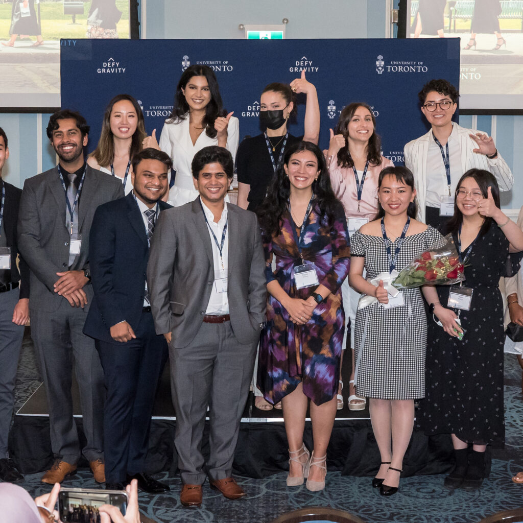 The graduating Pearson Scholars smile and give the thumbs up as they pose for a photo.