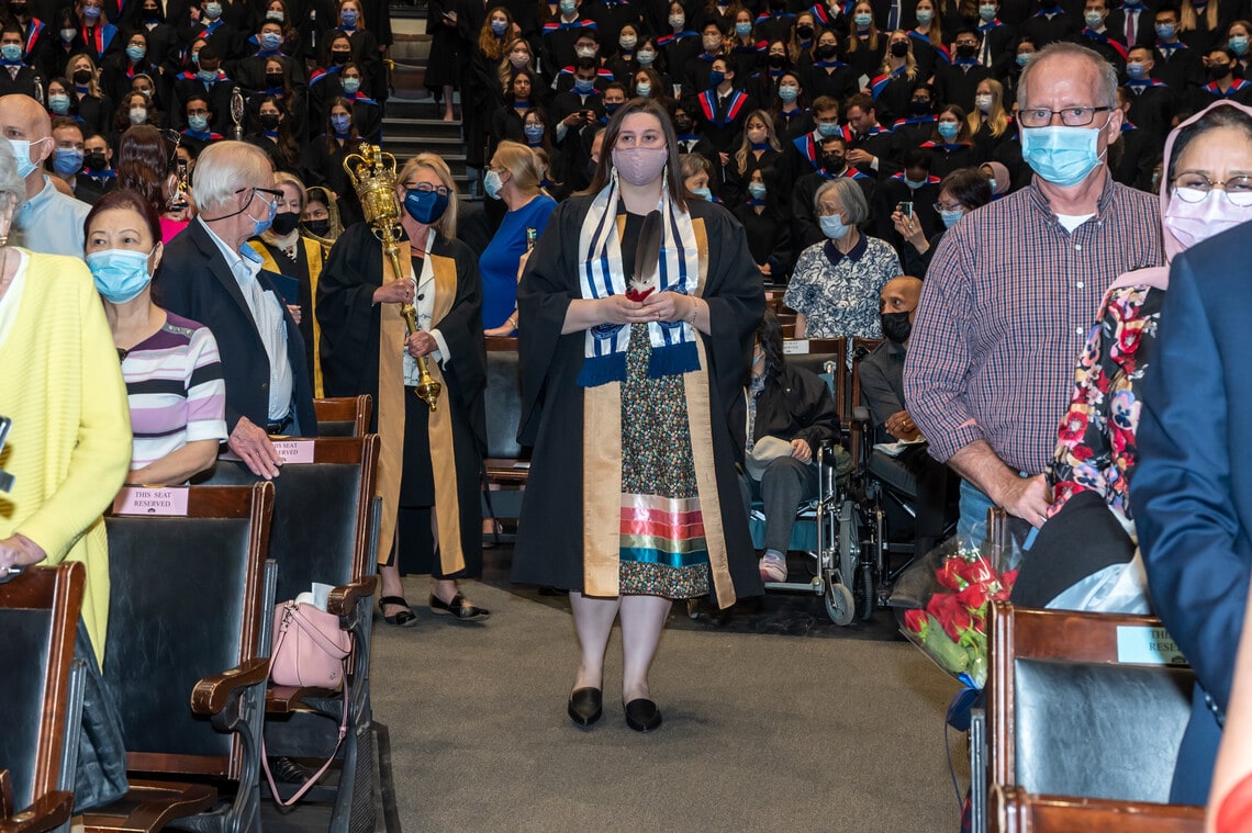Lindsey Fechtig walks down the aisle at Convocation Hall
