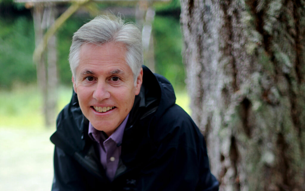 Photo of John Borrows smiling outdoors.