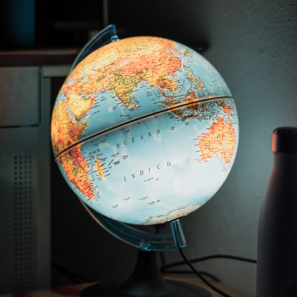 A globe, lit from within, glows in dark room. Africa, India and Australia are all visible.
