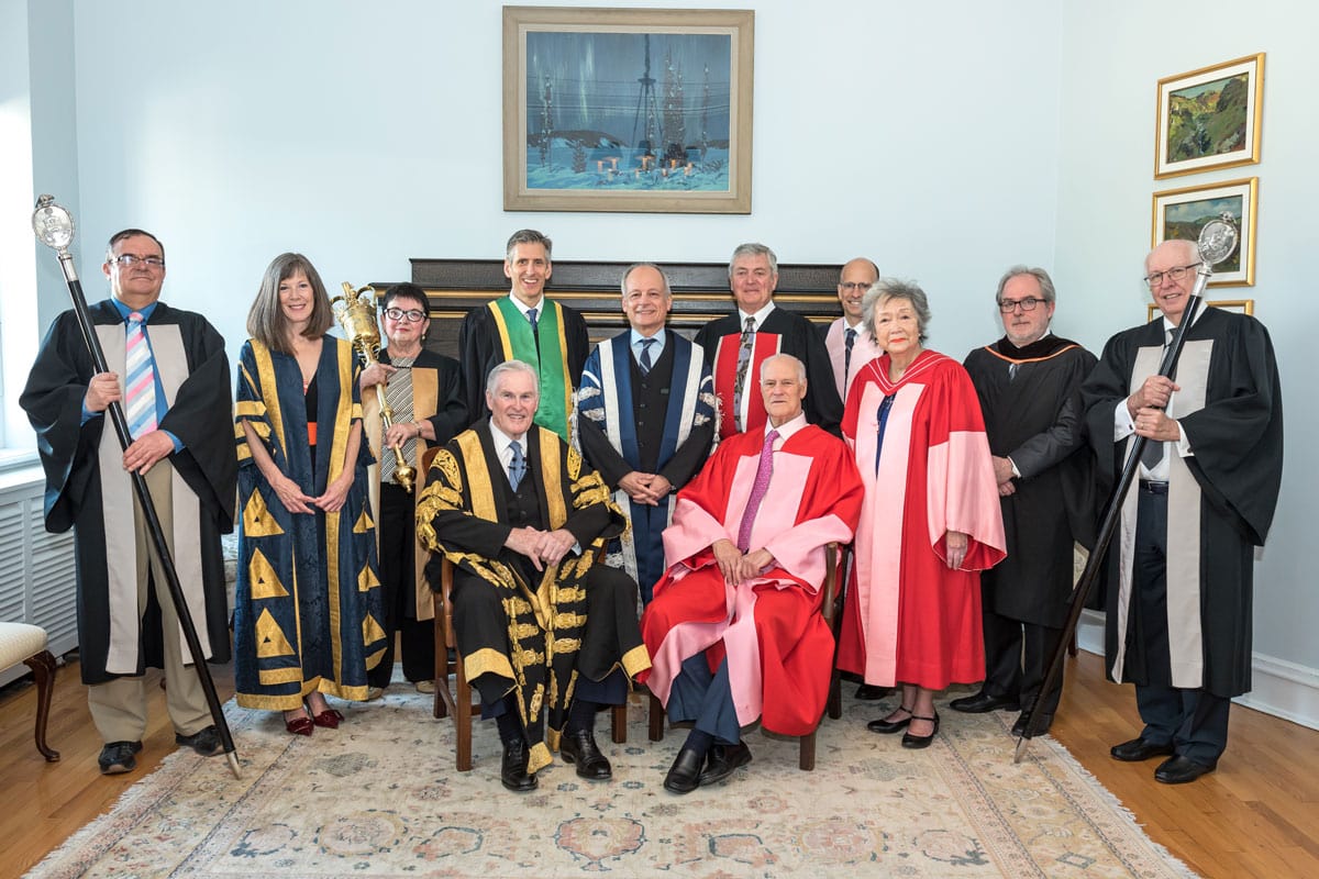 Bill Graham and U of T dignitaries, all wearing academic robes, pose for a formal portrait.