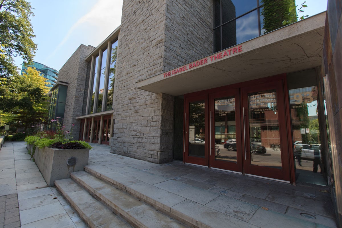 The Isabel Bader Theatre is written over the door of a building with huge windows and a big row of doors.