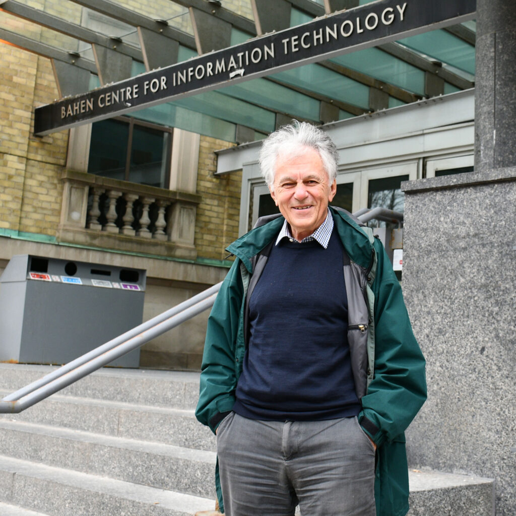 Velimir Jurdjevic smiling and standing on the steps of the Bahen Centre for Information Technology.