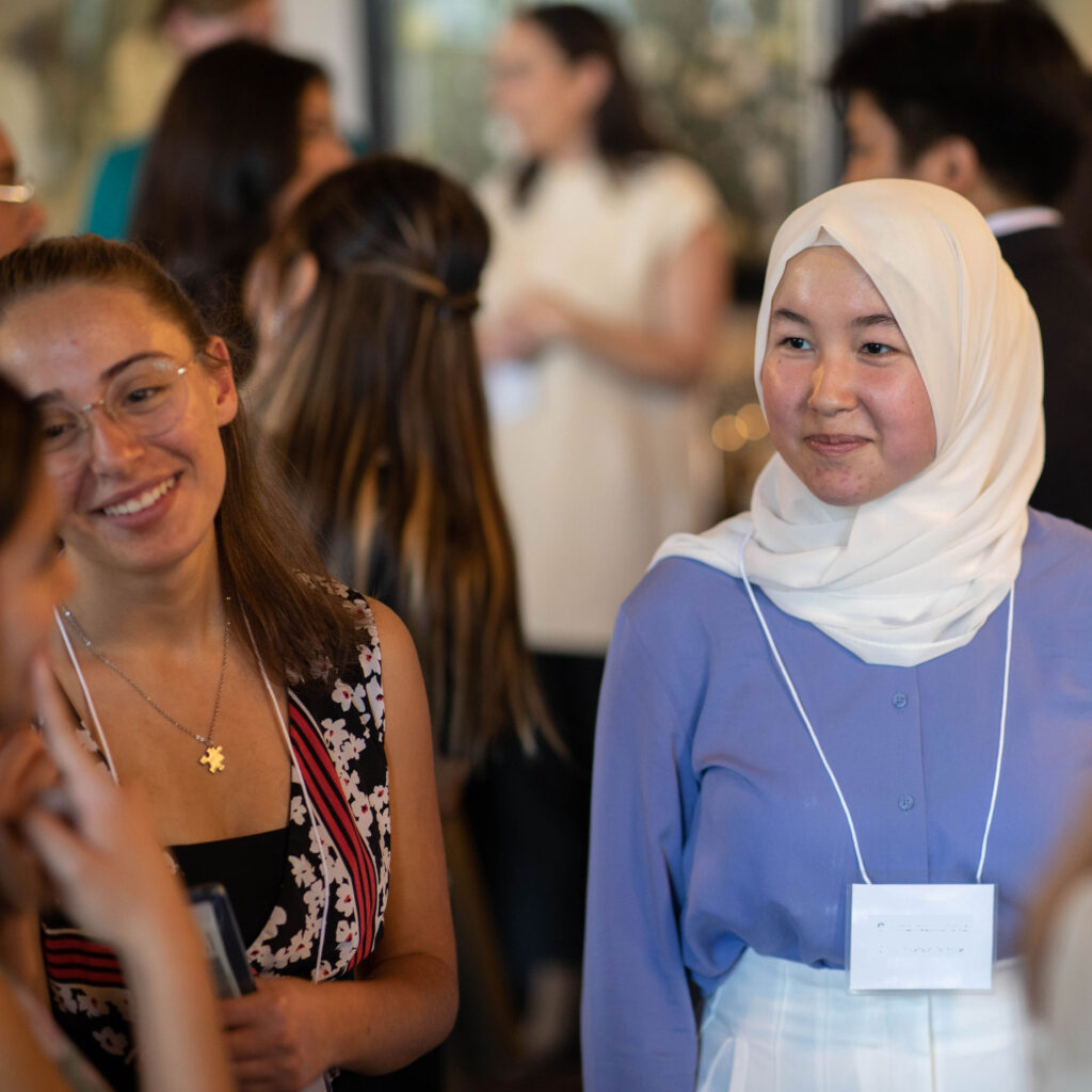 Omina Nematova smiles and chats at a party.