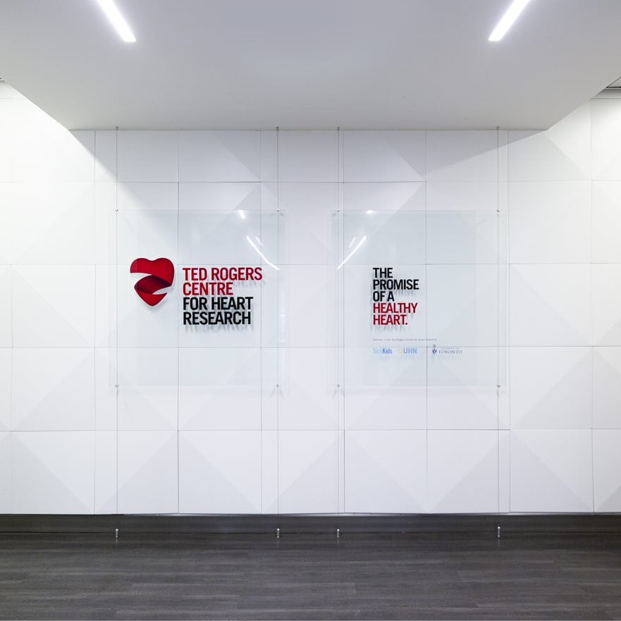Signs on a wall: Ted Rogers Centre for Heart Research, the promise of a healthy heart.