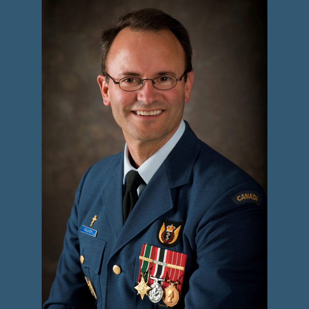 Colonel Carl Walker smiling and wearing his military surgeon uniform with three medals.