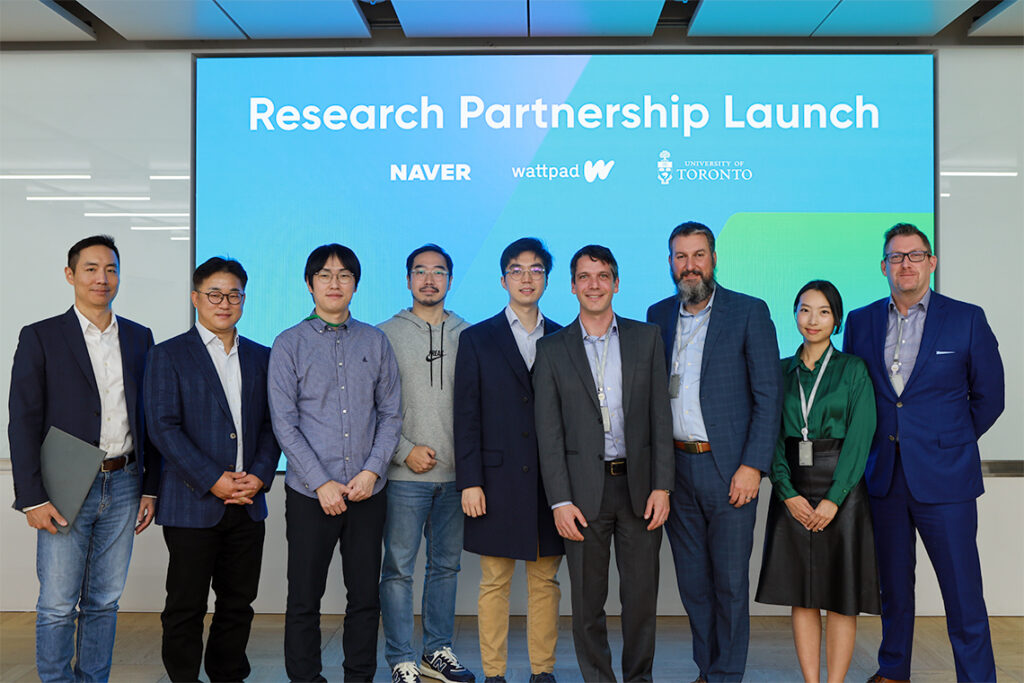 Researchers and executives pose for a picture at the partnership launch.