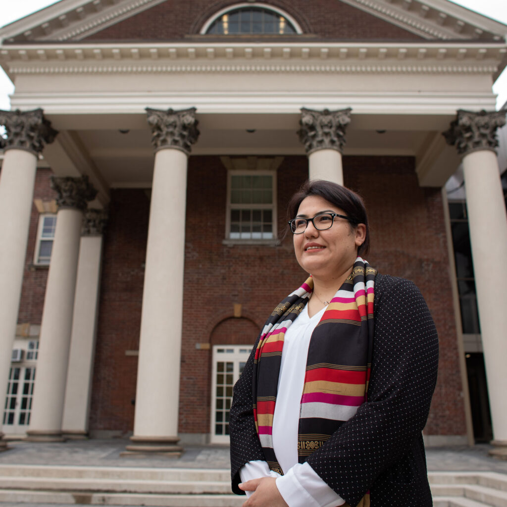 Ghizal Haress smiling in front of the Jackman Law Building.