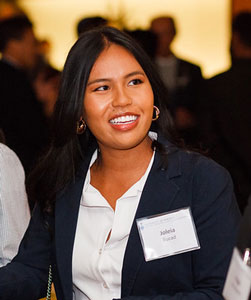 Joleia Marie Bucad smiles as she chats with fellow guests at a reception..