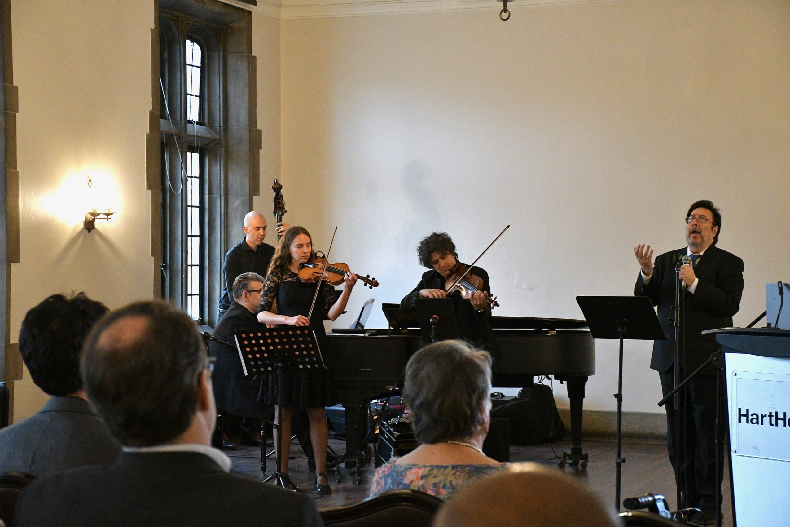 A musical performance with three musicians and a singer