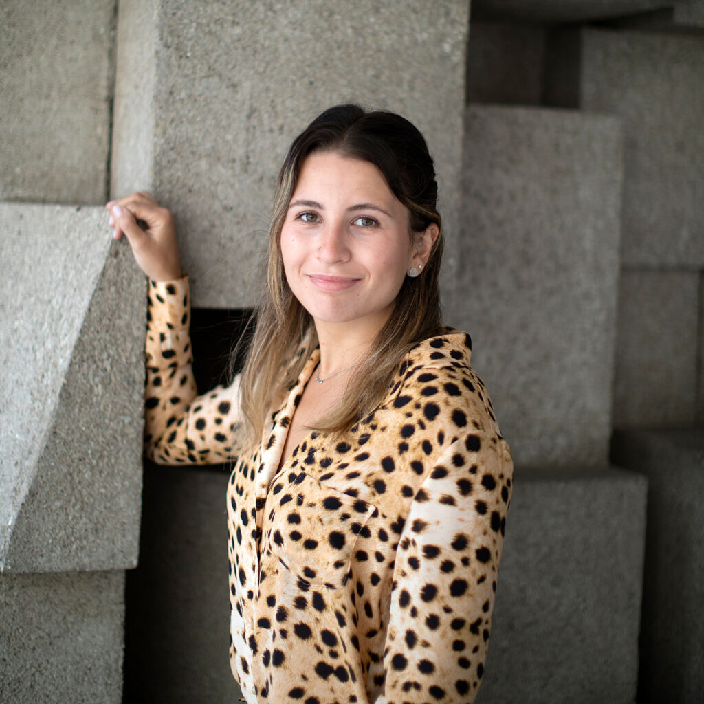 Victoria Mintsopoulos smiles as she stands by the concrete cubes outside the Medical Sciences Building.