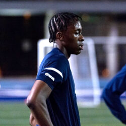 Kingsley Belele, wearing an OUA t-shirt, looks thoughtful after a soccer workout.