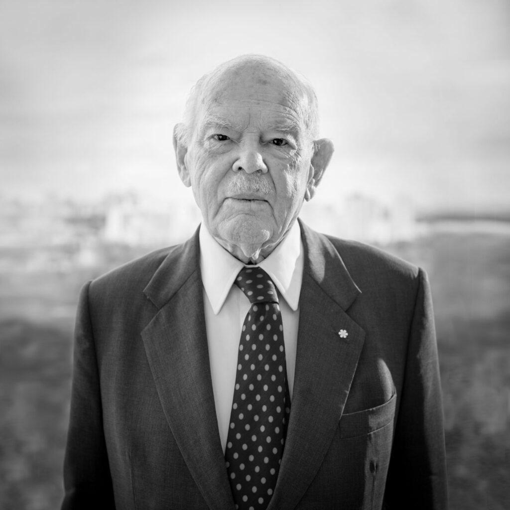 Gerald Heffernan wearing his Order of Canada pin and looking straight at the viewer.