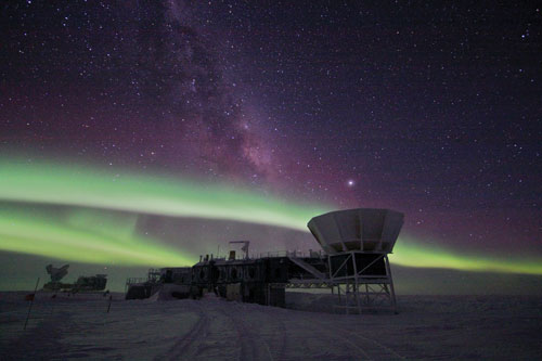 The Southern Lights make ghostly streaks across a starry sky above the South Pole Telescope.