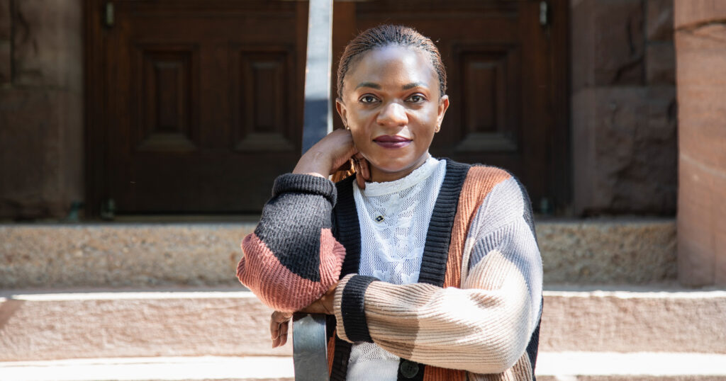 Catherine Kyakuhaire standing outside of Woodsworth College at U of T