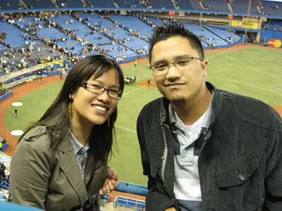 Cherrie and Christopher Chiu sitting together at a baseball game.
