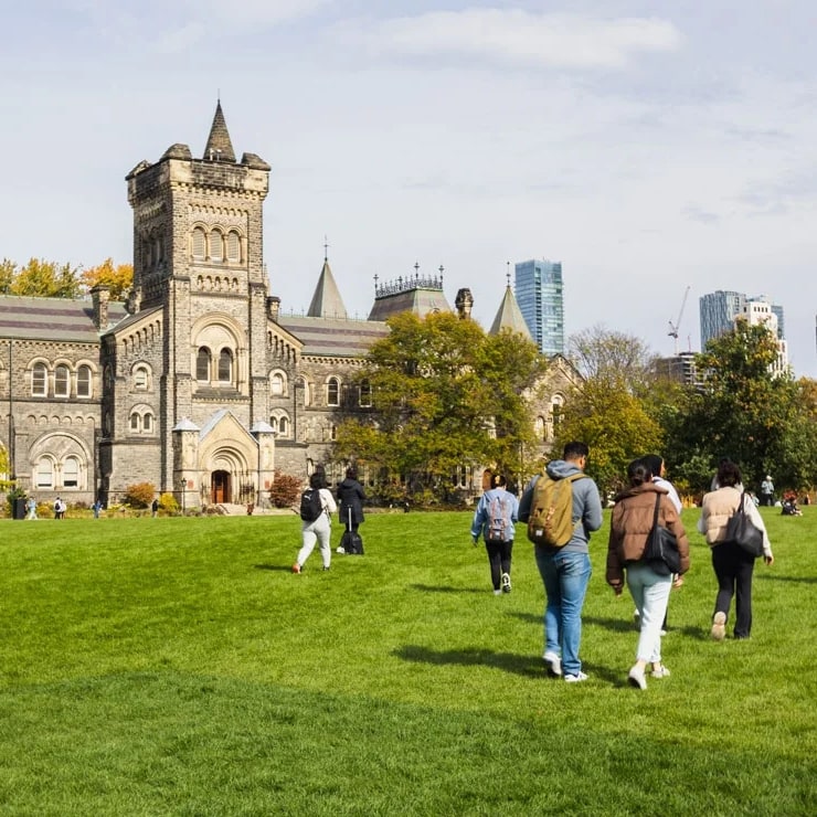 Outdoor shot of U of T campus with students walking by.