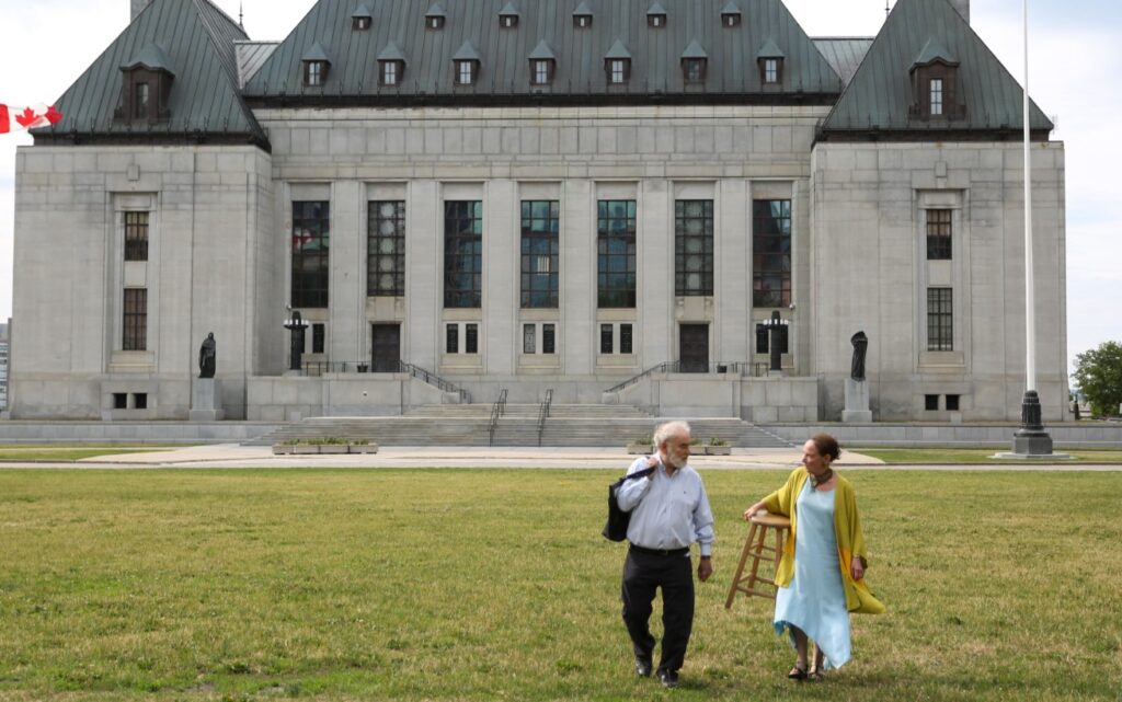 Two people in front of a courthouse