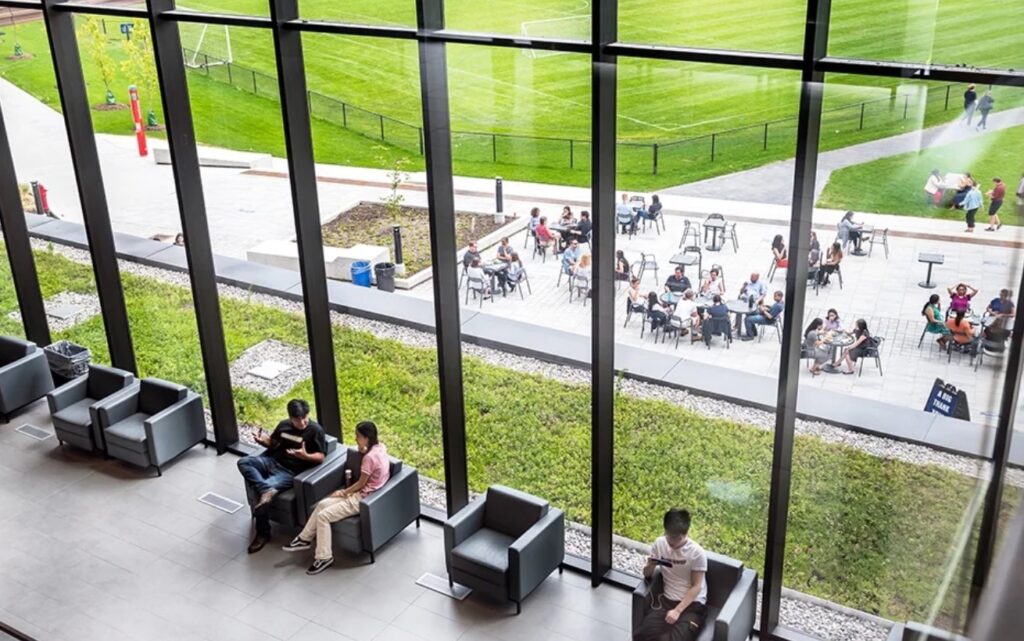 Students in a lounge area next to a big window