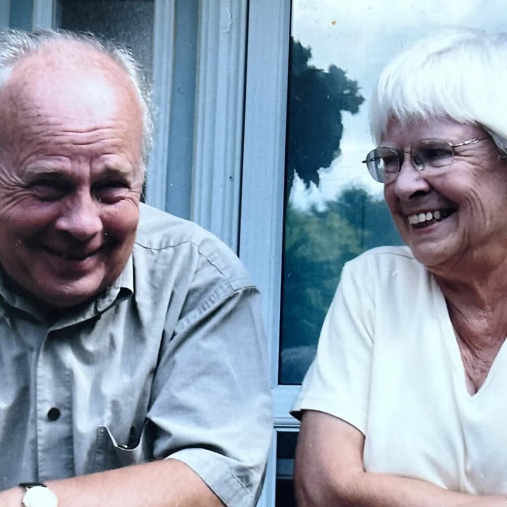 Timothy J. McGee and Bonnie McGee sitting together and smiling