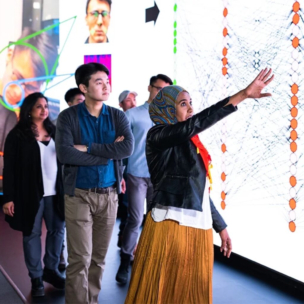 A group of people touring a science facility