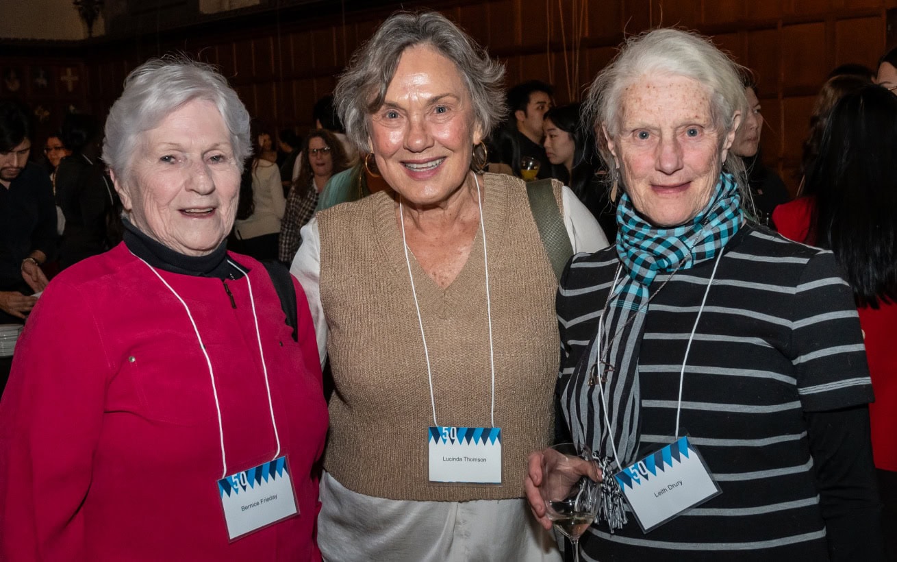 Three women posing at a social gathering