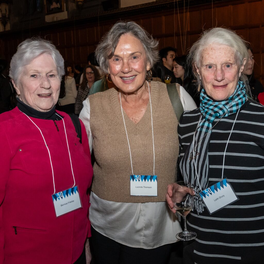 Three women posing at a social gathering