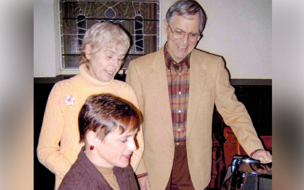 An archive photo of Joan and Michael Maloney at a piano