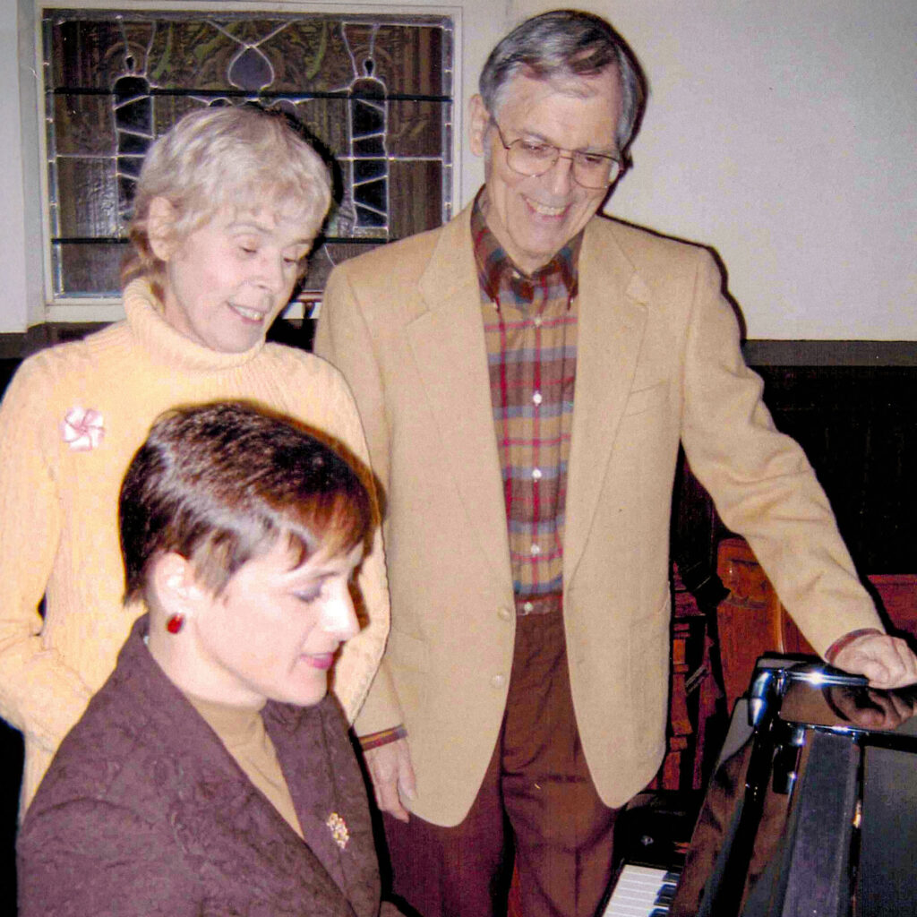 An archive photo of Joan and Michael Maloney at a piano